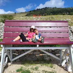 Una donna e un bambino si godono una pausa su una panchina in una montagna vicino Roma.