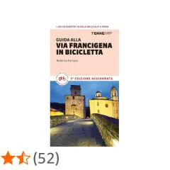 Guida alla Via Francigena in bici, un percorso di 1.000 km dalle Alpi a Roma. Immagine di un ponte medievale illuminato.