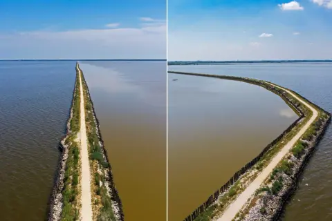 La ciclabile degli angeli, un sentiero che divide acque limpide e torbide, si estende all'infinito sotto un cielo azzurro.