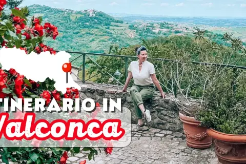 Un itinerario in Valconca, Rimini, tra colline verdi e rose rosse. Una donna sorride godendosi il panorama.