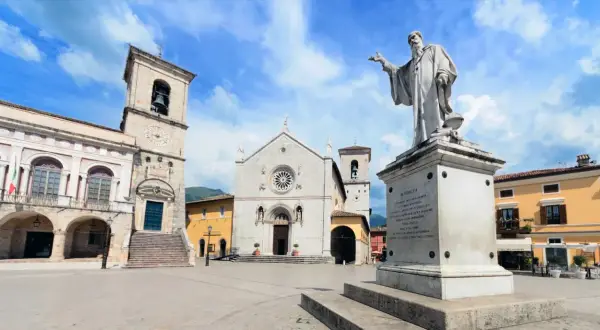 Norcia, famosa per San Benedetto, patrono d'Europa, con la sua basilica e il monumento in piazza.