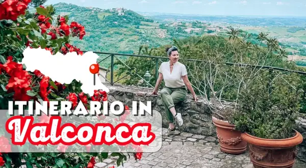 Un itinerario in Valconca, Rimini, tra colline verdi e rose rosse. Una donna sorride godendosi il panorama.